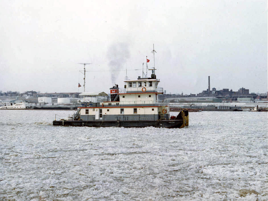 side view of a small white ship on an icy river
